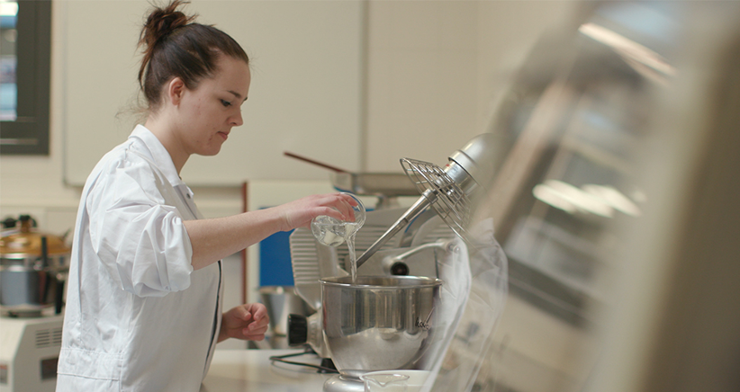 Lab assistant mixing ingredients in a Human Nutrition Laboratory