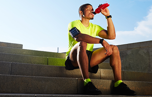 Runner drinking an energy drink fortified with Barentz Vitamin Energy premix