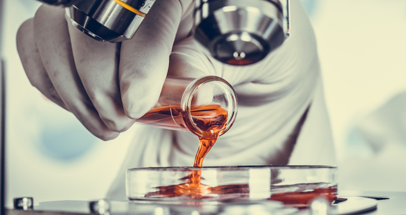 Lab assistant mixing liquids in a Personal Care Laboratory