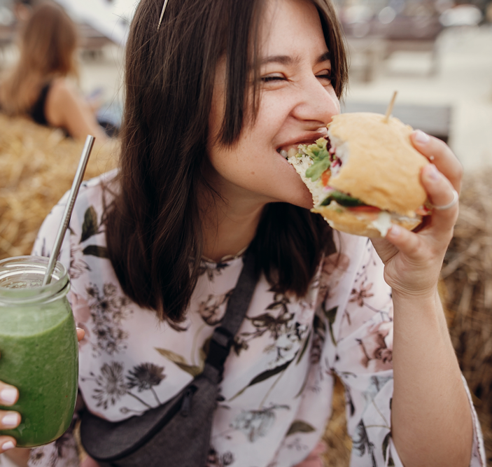 woman enjoying a healthy vegan burger