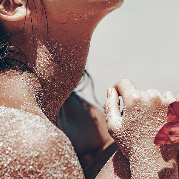 Woman on the beach covered in sand